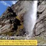 Vasudhara Falls cascading down the Himalayan cliffs near Badrinath, surrounded by lush greenery and mist—an enchanting stop on the Luxury Char Dham Yatra Package.